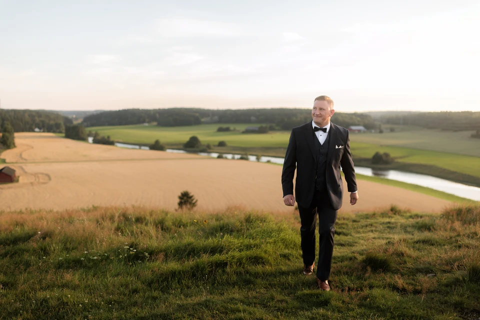 Anders Wahlberg overlooking fields and a river in evening light